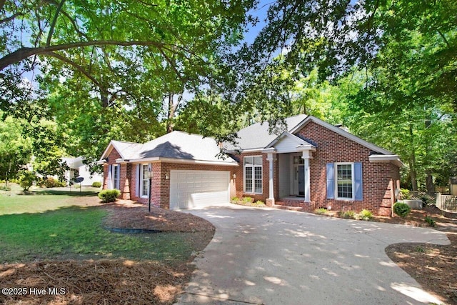 single story home featuring brick siding, asphalt driveway, an attached garage, and a front yard