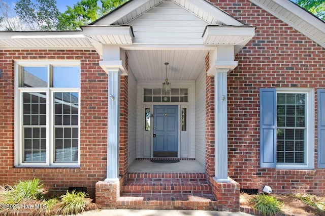 doorway to property with brick siding