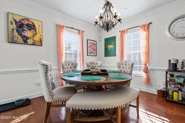 dining area featuring crown molding, an inviting chandelier, plenty of natural light, and hardwood / wood-style flooring