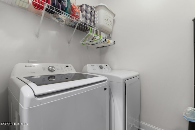 clothes washing area with independent washer and dryer and laundry area
