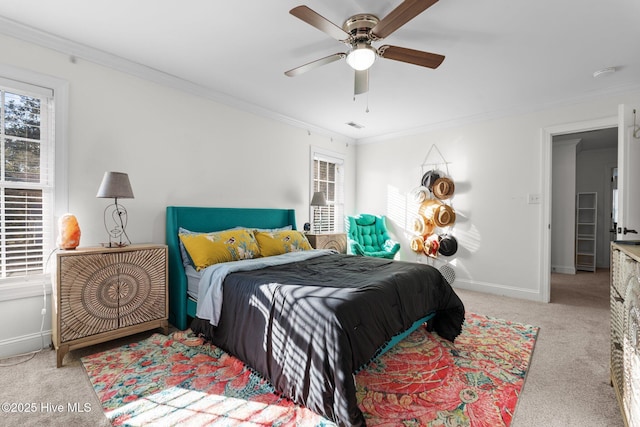 carpeted bedroom featuring baseboards, ornamental molding, and a ceiling fan