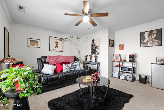 living room with visible vents, carpet floors, ornamental molding, and ceiling fan