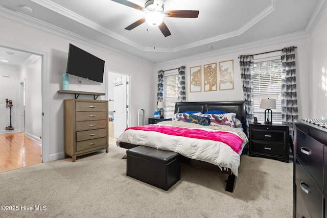 bedroom featuring ornamental molding, baseboards, multiple windows, and light carpet