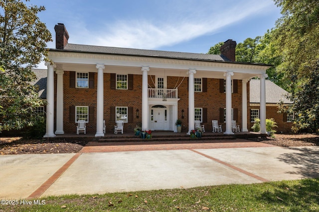 130 Harbour Dr, Hubert, NC 28539 - greek revival inspired property featuring a chimney, covered porch, and brick siding