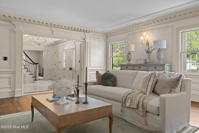 130 Harbour Dr, Hubert, NC 28539 - living area featuring a decorative wall, stairs, hardwood / wood-style floors, ornamental molding, and a chandelier