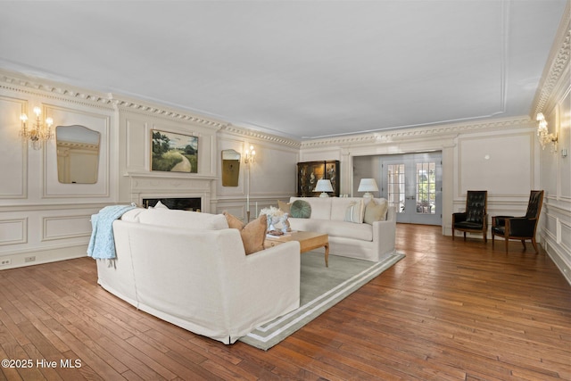 130 Harbour Dr, Hubert, NC 28539 - living area featuring a decorative wall, a chandelier, ornamental molding, a fireplace, and hardwood / wood-style floors