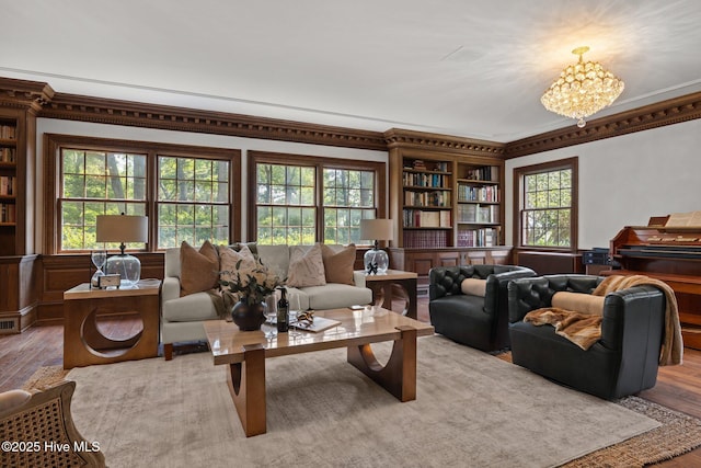 130 Harbour Dr, Hubert, NC 28539 - living area with wood finished floors, ornamental molding, a chandelier, and built in shelves