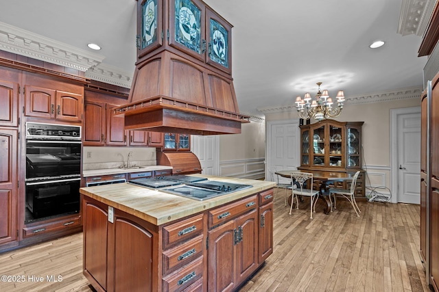 130 Harbour Dr, Hubert, NC 28539 - kitchen with black appliances, crown molding, butcher block counters, a chandelier, and light wood-type flooring
