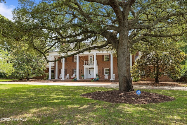 130 Harbour Dr, Hubert, NC 28539 - greek revival house featuring a front lawn and brick siding