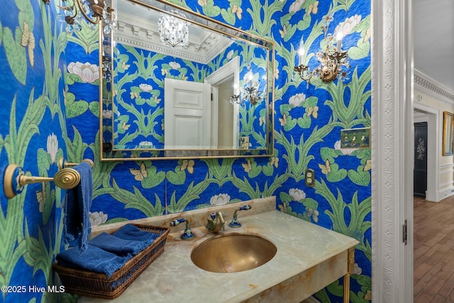 130 Harbour Dr, Hubert, NC 28539 - bathroom featuring wallpapered walls, crown molding, wood finished floors, vanity, and a chandelier