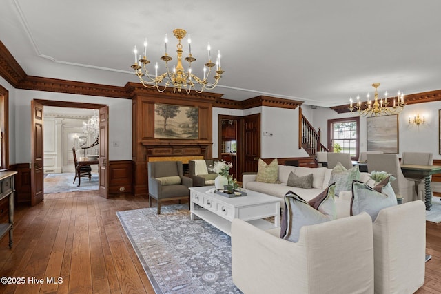 130 Harbour Dr, Hubert, NC 28539 - living room with a chandelier, hardwood / wood-style flooring, stairway, ornamental molding, and a wainscoted wall