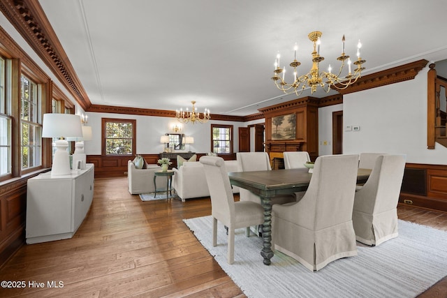 130 Harbour Dr, Hubert, NC 28539 - dining room with a chandelier, ornamental molding, light wood-type flooring, and wainscoting