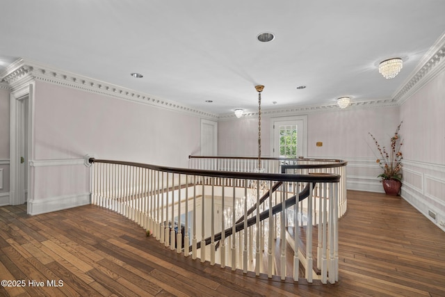 130 Harbour Dr, Hubert, NC 28539 - corridor with hardwood / wood-style flooring, an upstairs landing, crown molding, a decorative wall, and a wainscoted wall