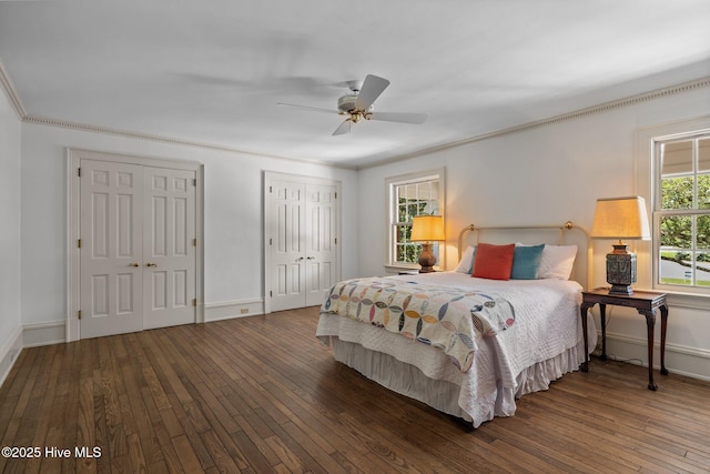 130 Harbour Dr, Hubert, NC 28539 - bedroom featuring wood-type flooring, baseboards, two closets, a ceiling fan, and crown molding