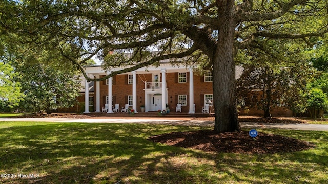 130 Harbour Dr, Hubert, NC 28539 - greek revival inspired property with a front lawn and brick siding