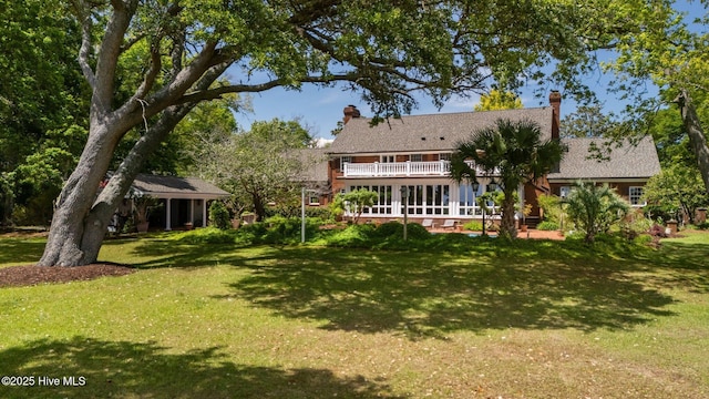 130 Harbour Dr, Hubert, NC 28539 - rear view of property with a lawn, a balcony, and a chimney