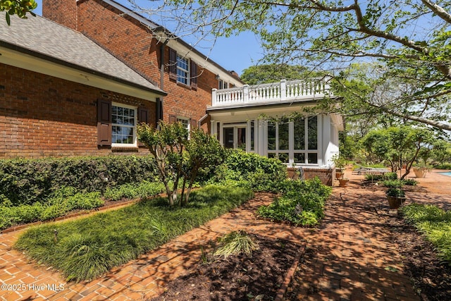 130 Harbour Dr, Hubert, NC 28539 - back of house with brick siding, a balcony, roof with shingles, and a chimney