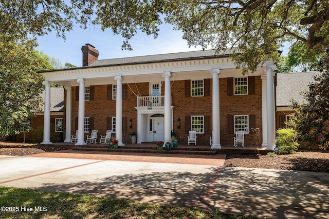 130 Harbour Dr, Hubert, NC 28539 - neoclassical / greek revival house with a porch, brick siding, and a chimney