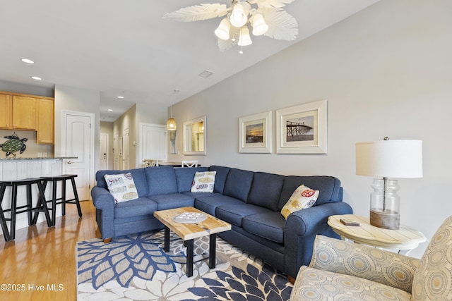 living room with recessed lighting, light wood-style flooring, visible vents, and a ceiling fan