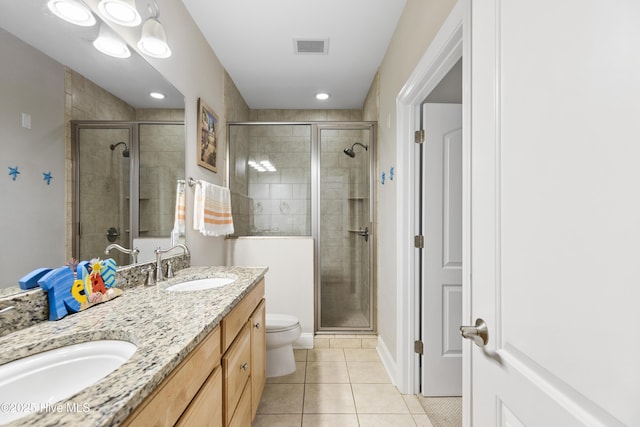 bathroom with tile patterned flooring, double vanity, visible vents, a sink, and a stall shower