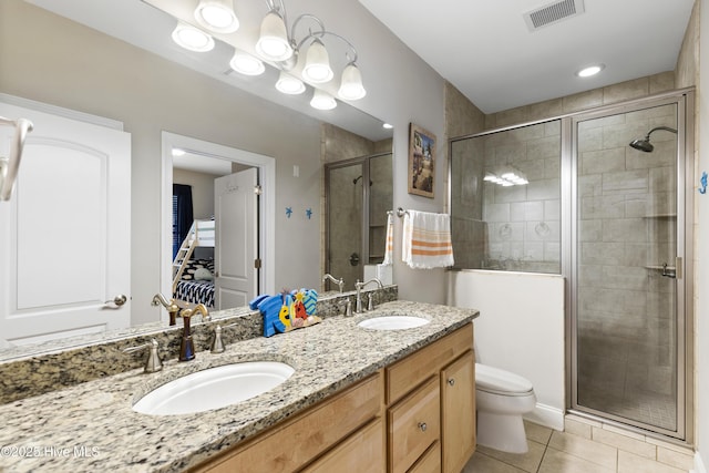 bathroom with visible vents, a stall shower, and a sink