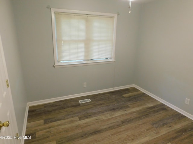 17261 Harvell Ln, Laurinburg, NC 28352 - spare room featuring dark wood-type flooring and baseboards
