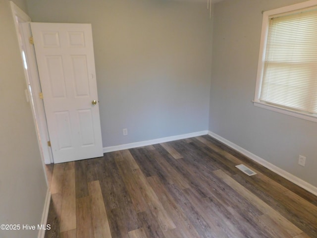 17261 Harvell Ln, Laurinburg, NC 28352 - unfurnished room with baseboards and dark wood-type flooring