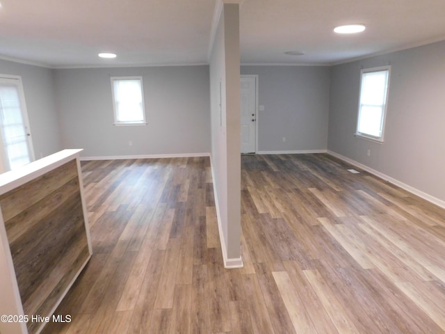 17261 Harvell Ln, Laurinburg, NC 28352 - below grade area featuring ornamental molding, plenty of natural light, wood finished floors, and baseboards
