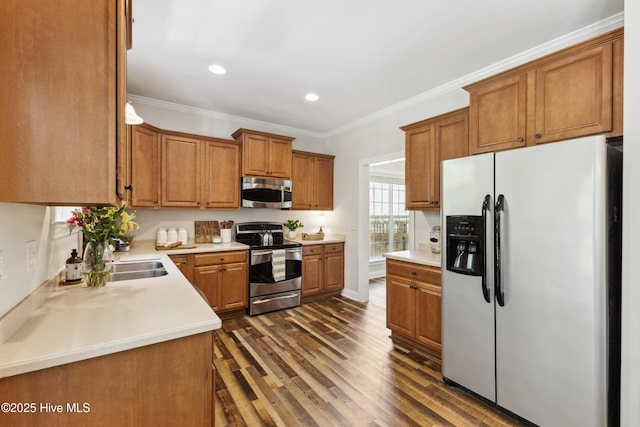 kitchen with stainless steel appliances, dark wood finished floors, brown cabinets, recessed lighting, and crown molding