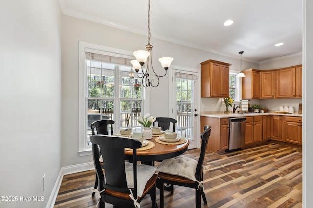 dining room with a chandelier, crown molding, dark wood finished floors, recessed lighting, and baseboards