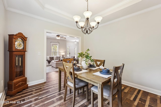 dining room with dark wood finished floors, a chandelier, baseboards, and ornamental molding
