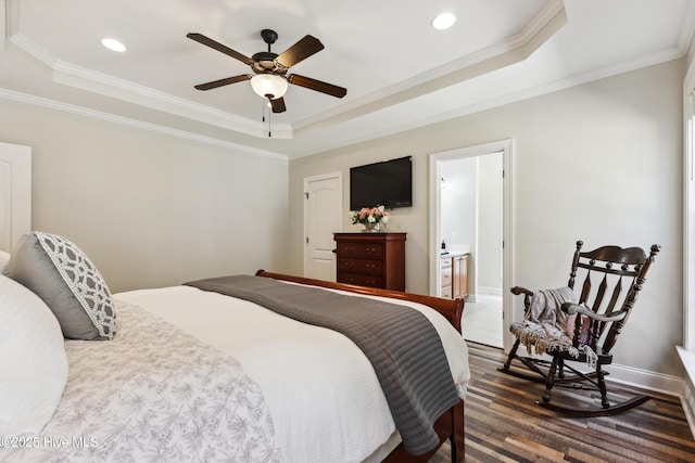 bedroom with a tray ceiling, crown molding, recessed lighting, baseboards, and a ceiling fan