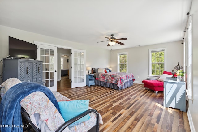 bedroom with french doors, wood finished floors, baseboards, and a ceiling fan
