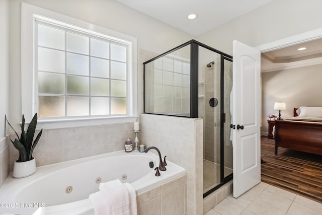 ensuite bathroom featuring a shower stall, tile patterned floors, a jetted tub, ornamental molding, and recessed lighting