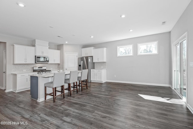 138 Clear Water Rd, Louisburg, NC 27549 - kitchen with white cabinetry, an island with sink, stainless steel appliances, and dark wood finished floors