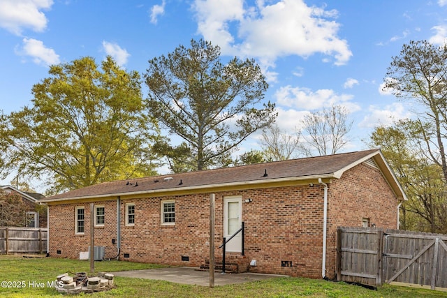 rear view of house with a patio area, fence, brick siding, entry steps, and crawl space