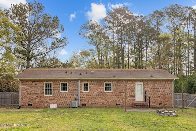 rear view of property featuring a patio, crawl space, and a yard