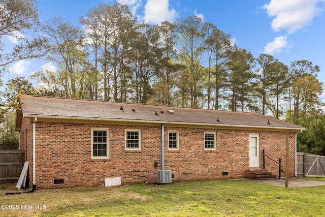 back of house with fence, central air condition unit, crawl space, a lawn, and a patio area
