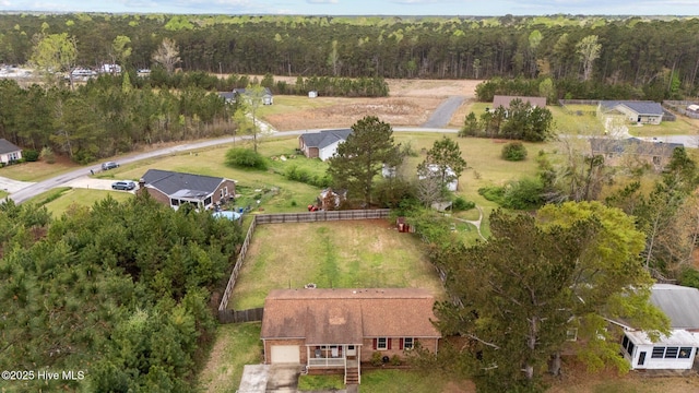 drone / aerial view featuring a wooded view