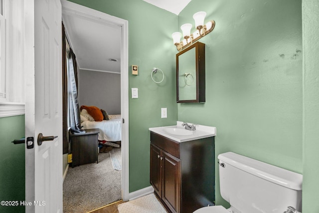 ensuite bathroom featuring ensuite bathroom, toilet, and vanity
