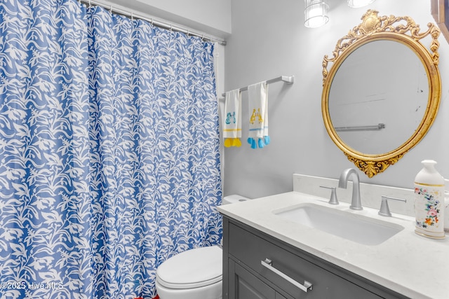 bathroom featuring toilet and vanity