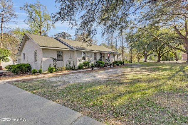 view of front of home with a front yard and brick siding