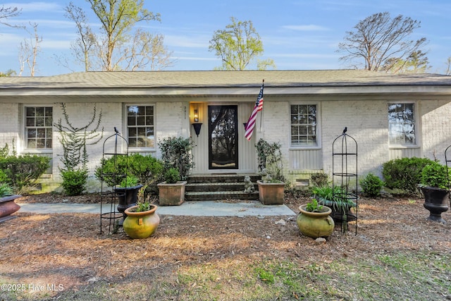 ranch-style home featuring brick siding
