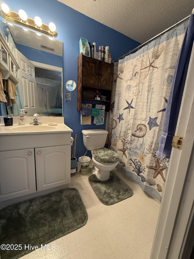 bathroom featuring a textured ceiling, visible vents, tile patterned floors, vanity, and toilet
