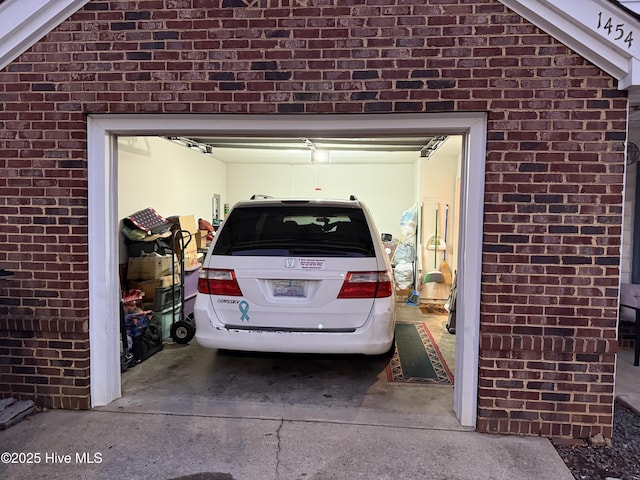 garage featuring concrete driveway