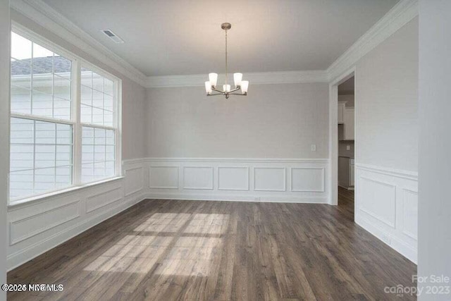 unfurnished dining area featuring visible vents, wainscoting, an inviting chandelier, and wood finished floors