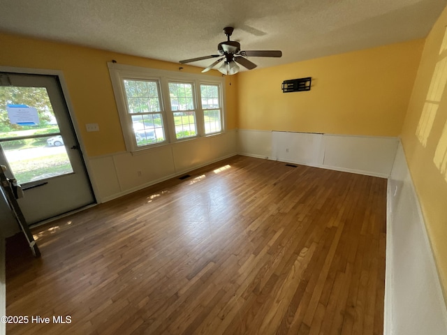 510 Sioux Dr, Jacksonville, NC 28540 - unfurnished room with wainscoting, wood finished floors, and ceiling fan