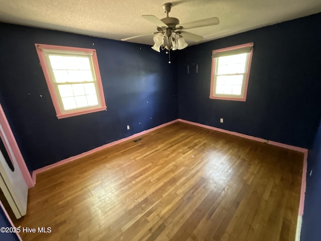 510 Sioux Dr, Jacksonville, NC 28540 - unfurnished room with wood finished floors, a textured ceiling, baseboards, and ceiling fan