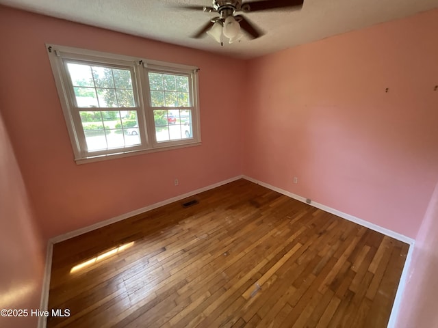 510 Sioux Dr, Jacksonville, NC 28540 - unfurnished room with baseboards, a ceiling fan, visible vents, and hardwood / wood-style flooring