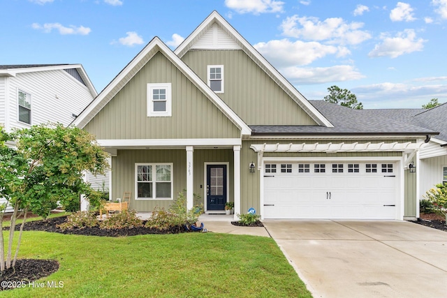 3763 Spicetree Dr, Wilmington, NC 28412 - view of front facade featuring roof with shingles, driveway, an attached garage, a front yard, and a porch